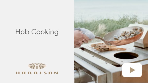Woman cooking shellfish on The Harrison Atom’s hob